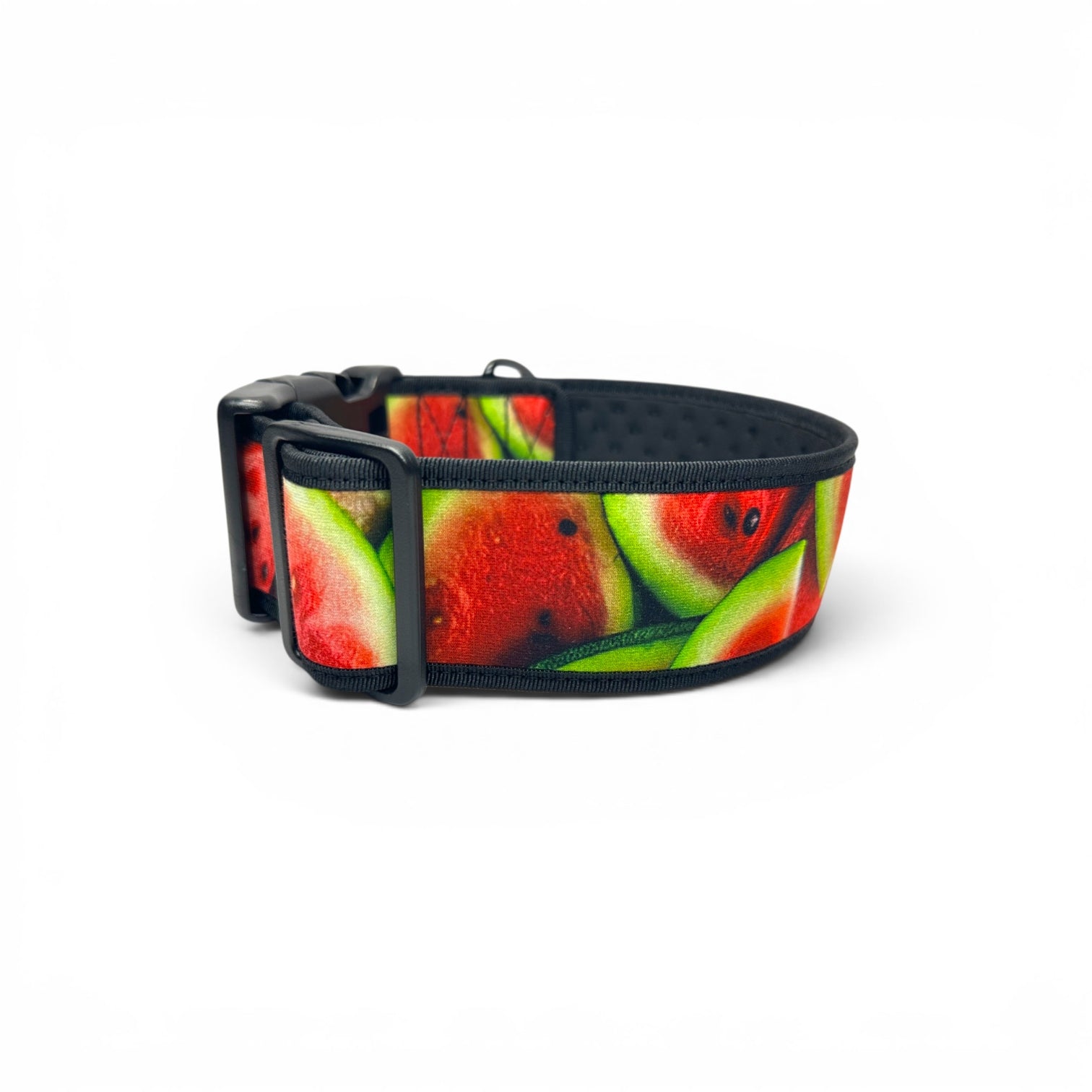 A dog collar featuring a vibrant watermelon slice pattern with red fruit, green rinds, and black plastic hardware, shown on a plain white background.